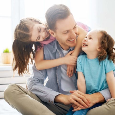 Happy loving family. Daddy and his daughters children girls play